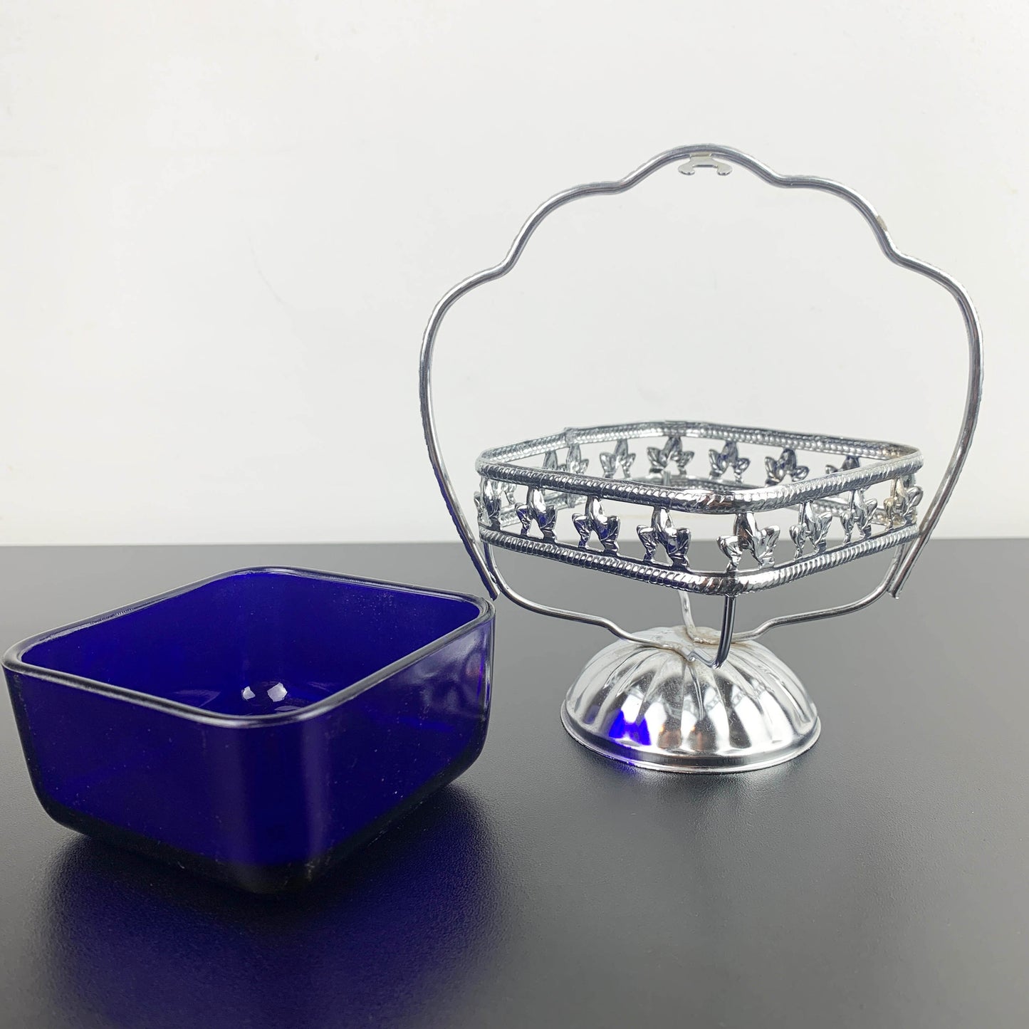 Ornate metal footed condiment bowl with cobalt blue glass insert