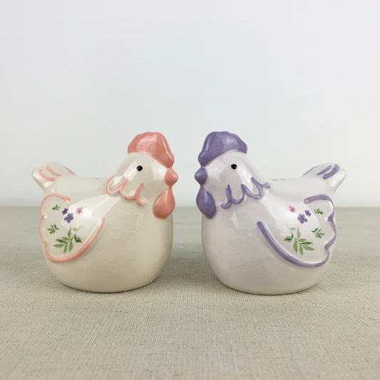 Two ceramic hen shakers with pastel colours
