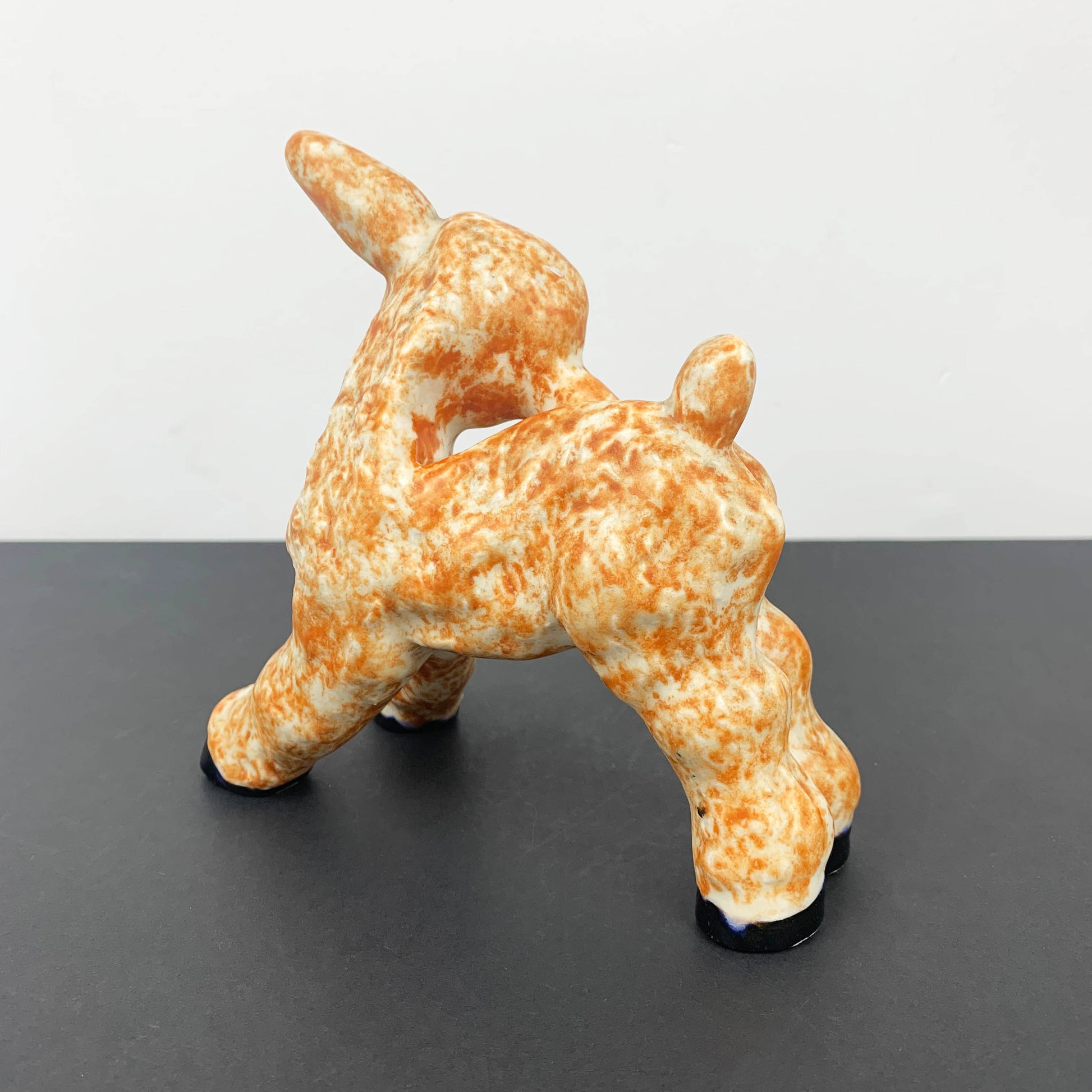 Kooky lamb figurine in mottled orange rear view