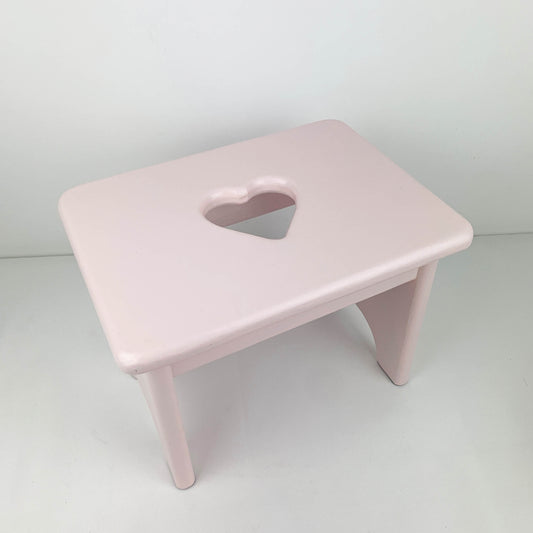Pink timber children's stool with heart cutout